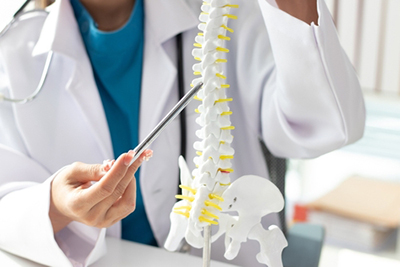 Doctor reviewing spinal anatomy and the Intracept technique for nerve-related pain relief.